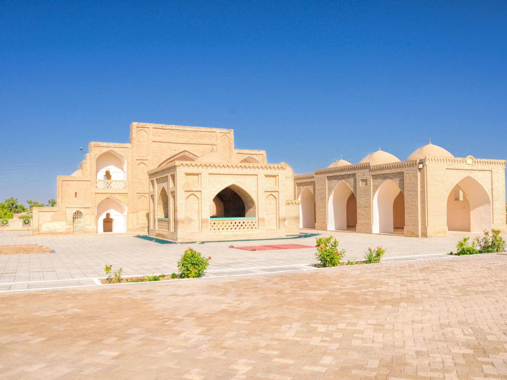 Historic palace complex in Merv, Turkmenistan, with arched courtyards and domed structures.