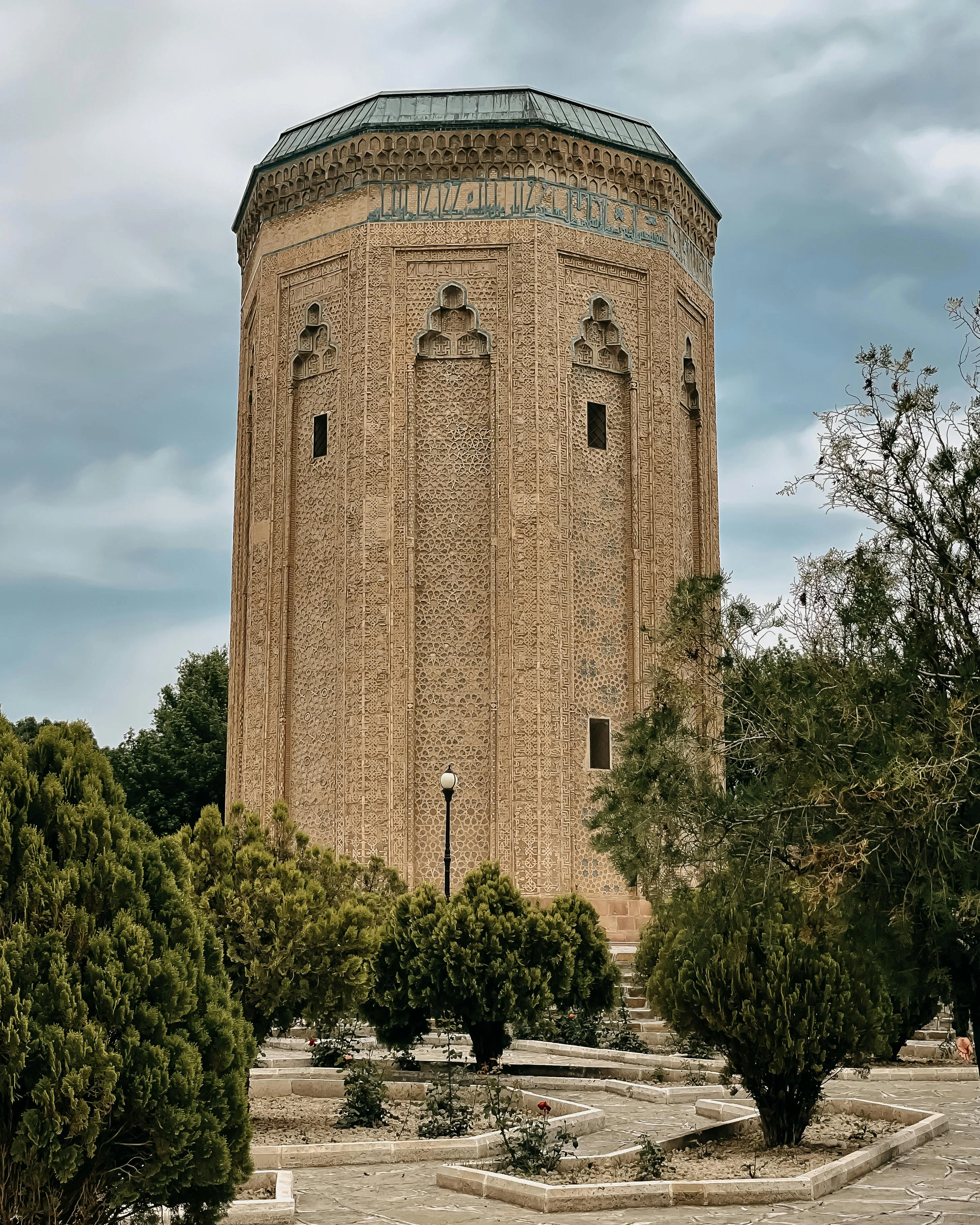 Mömine Hatun Mausoleum in Nakhchivan, Azerbaijan, an intricately designed cylindrical tower with Arabic inscriptions.
