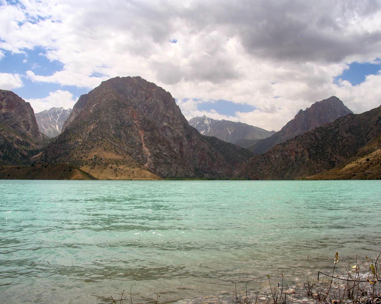 Another stunning view of Iskanderkul Lake in Tajikistan, reflecting the surrounding rugged peaks.