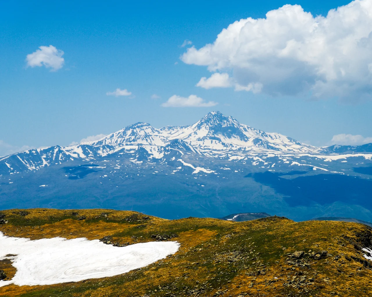 Snow-covered Mount Aragats, Armenia’s highest mountain, standing under a clear blue sky.