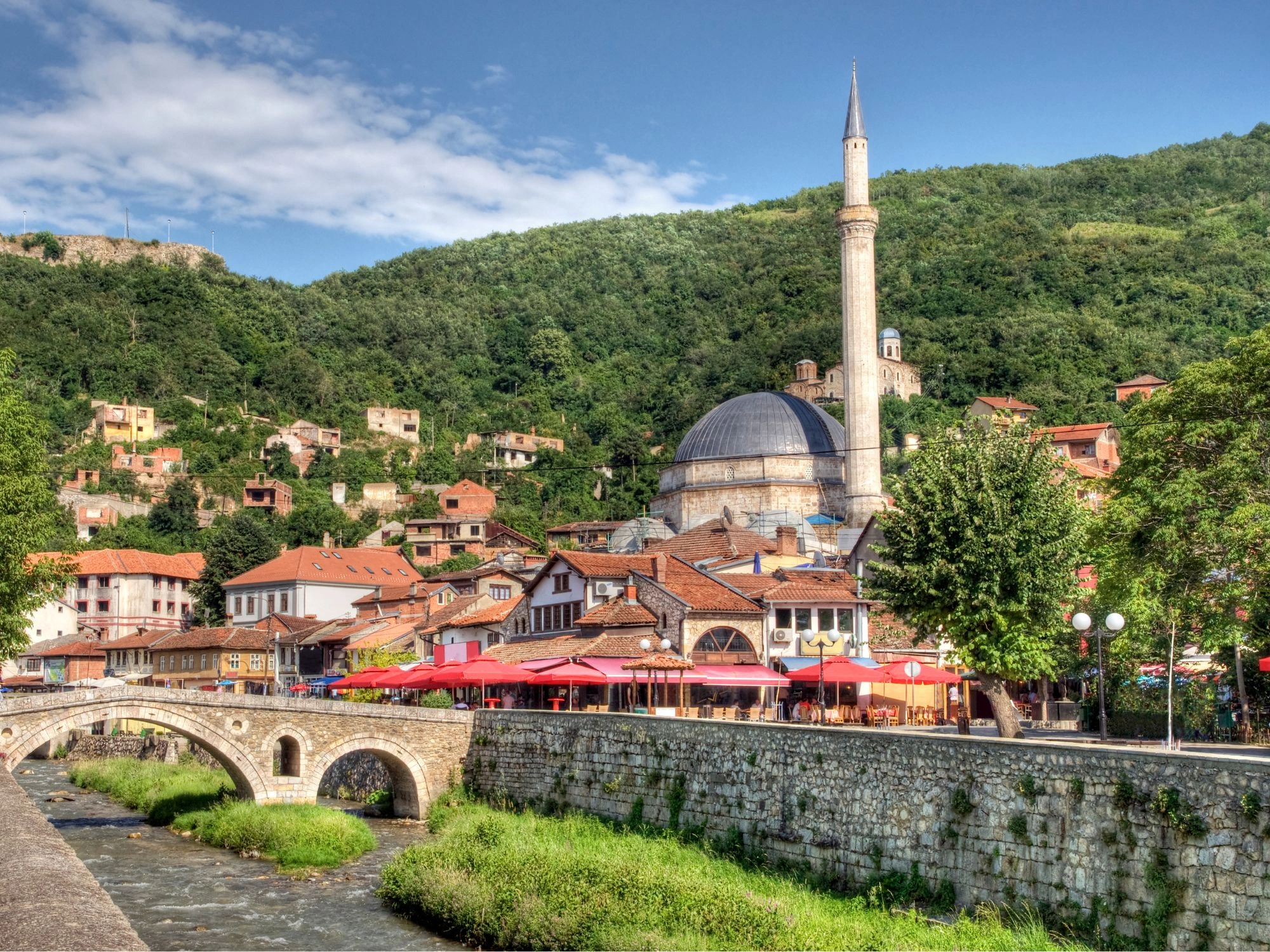 Kosovo – Prizren old town with Sinan Pasha Mosque, stone bridge, and hillside homes.