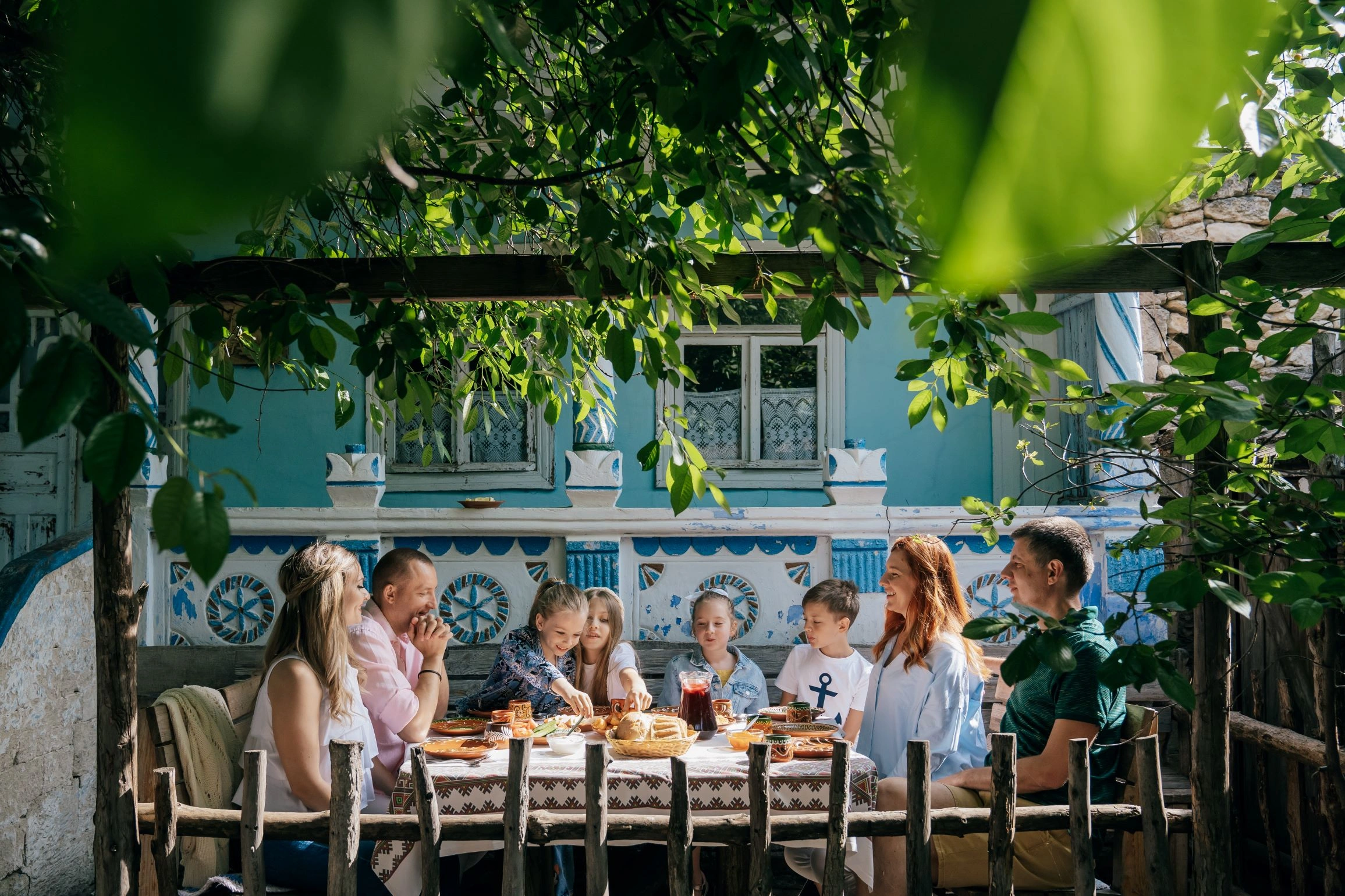 Family enjoying traditional meal outdoors at Butuceni Eco Resort in Moldova.