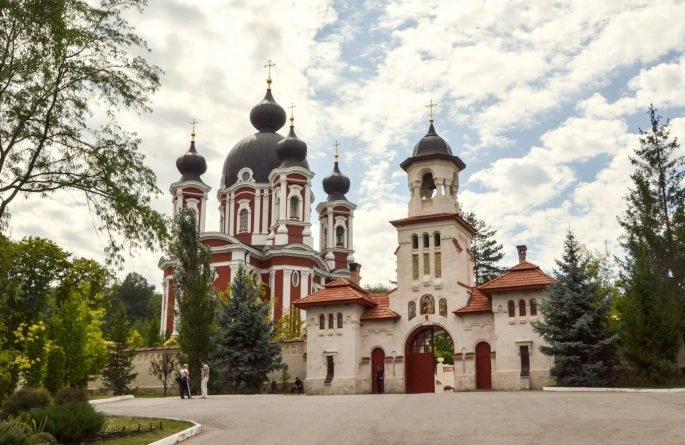 Colorful Curchi Monastery with domes and gated entrance in Moldova