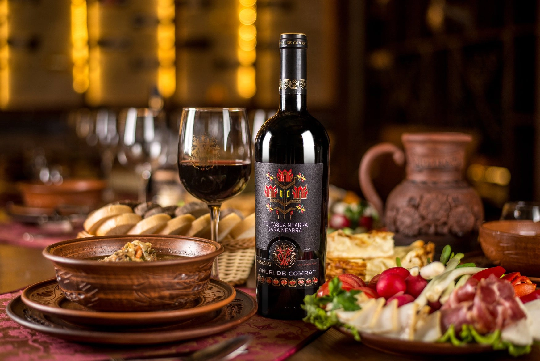 Moldovan dinner spread with Vinuri de Comrat wine and traditional dishes