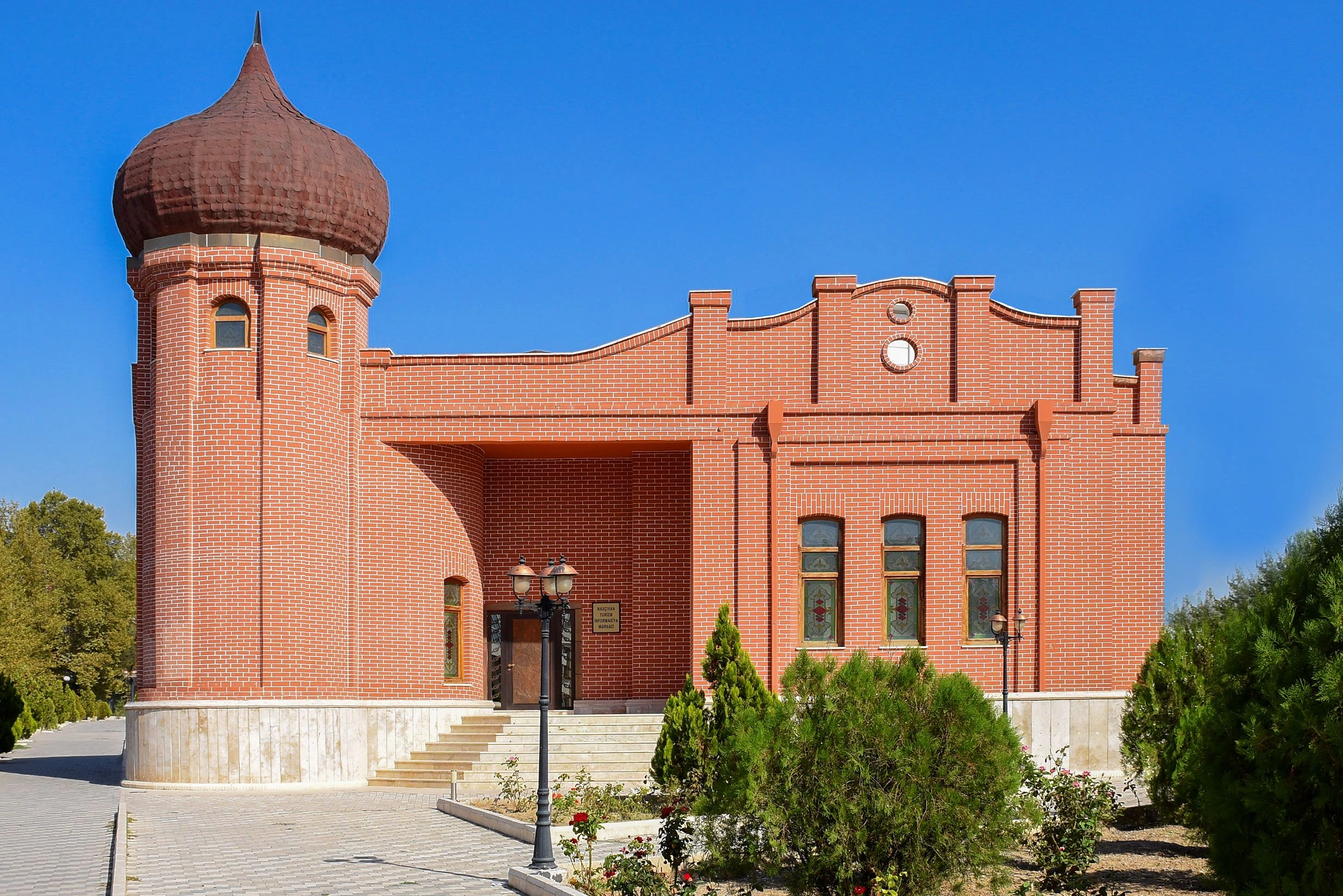 Red-brick Zaviyya Madrasa Complex stands out against the clear sky in Nakhchivan.