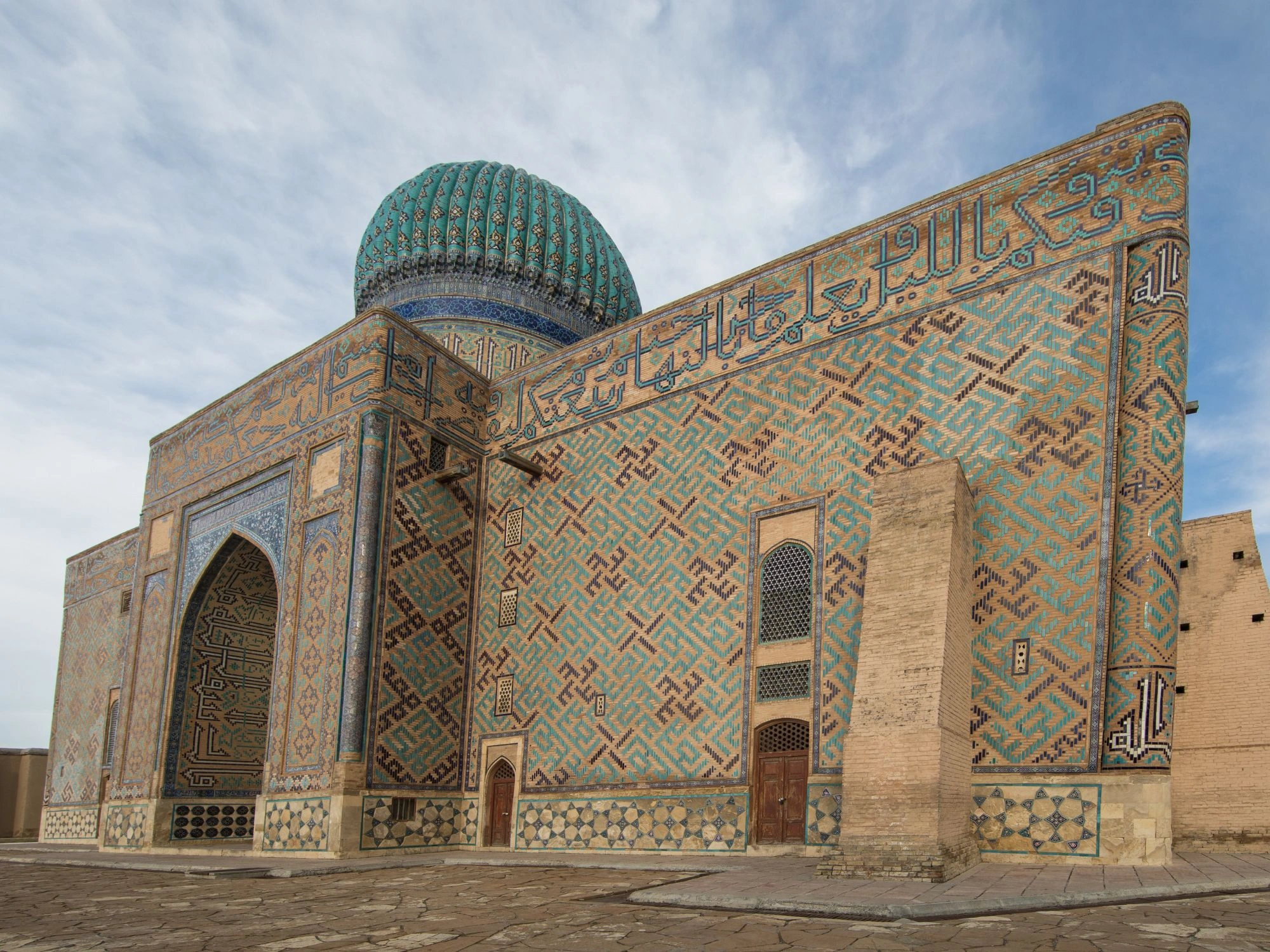 Mausoleum of Khoja Ahmed Yasawi with turquoise dome and mosaic tiles in Turkestan, Kazakhstan.