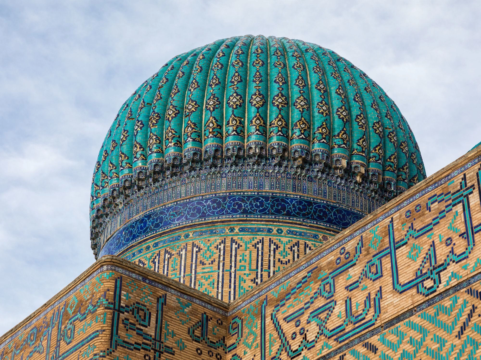 Close-up of turquoise dome with ornate tilework at Yasawi Mausoleum in Turkistan, Kazakhstan.