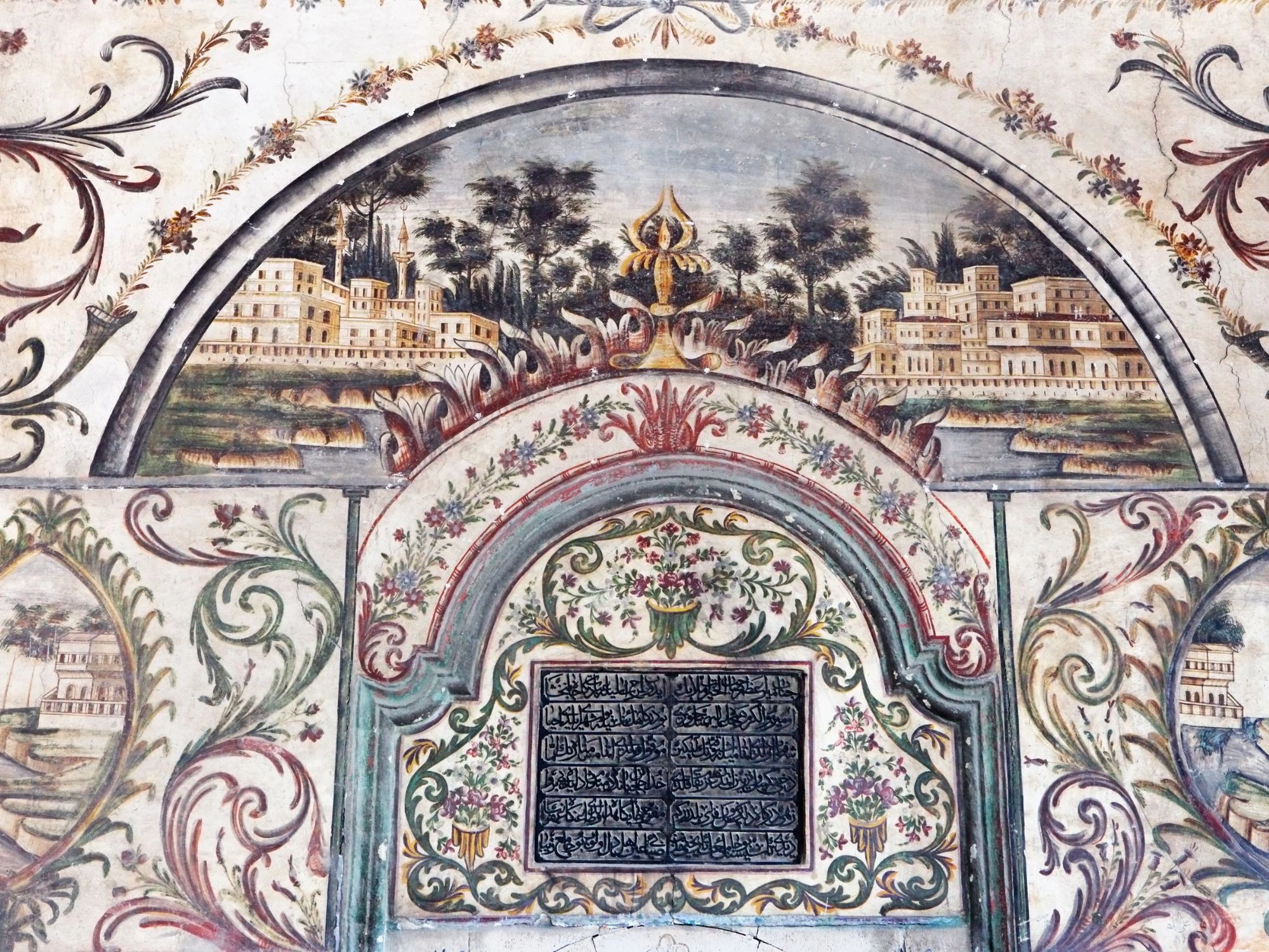 Detailed frescoes of floral and city scenes on the historic Ethem Bey Mosque walls in Tirana, Albania.