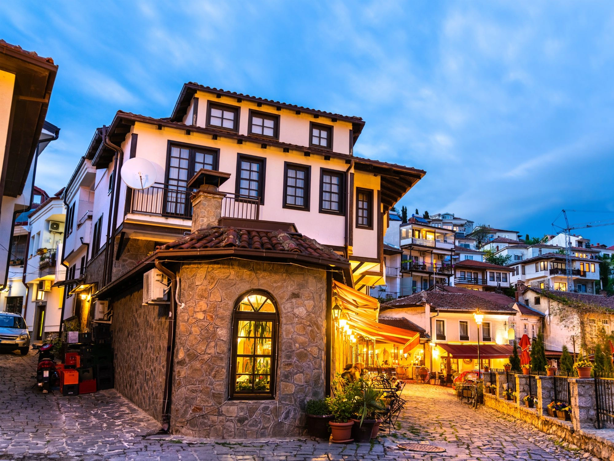 Cobblestone streets and cozy cafés in historic Old Town Ohrid, North Macedonia, at sunset.