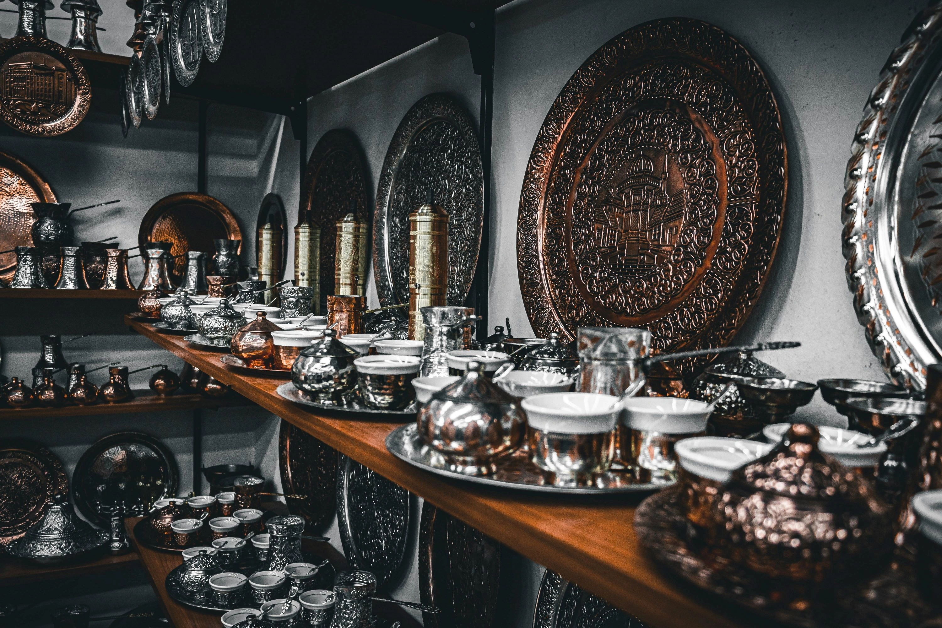 Traditional Bosnian copperware and coffee sets displayed in a Sarajevo bazaar.