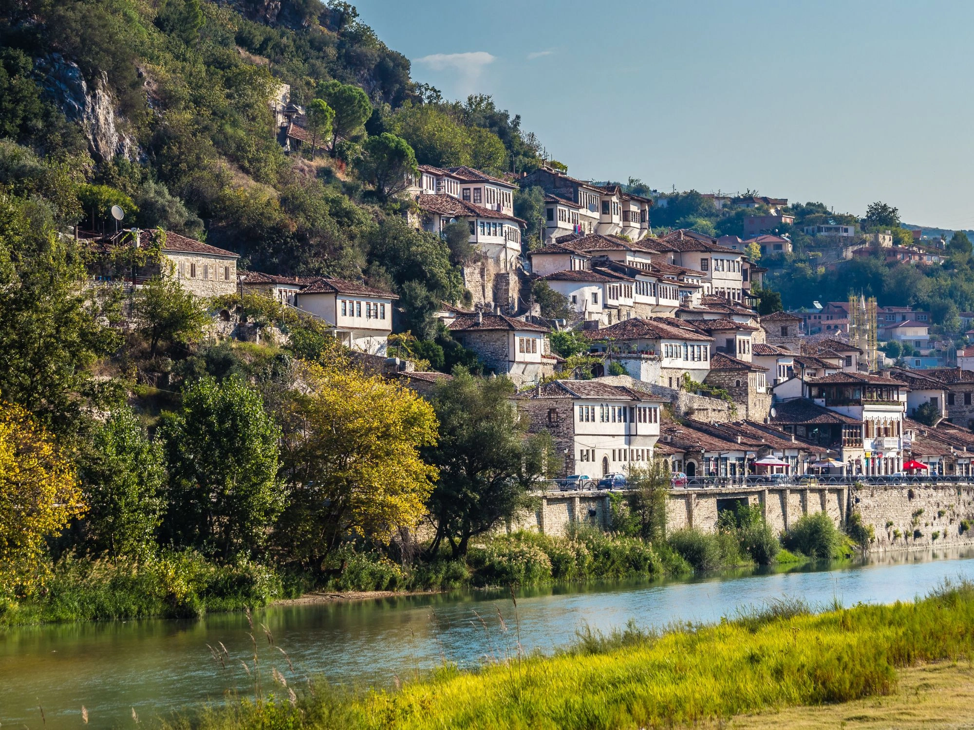 Historic white Ottoman houses stacked on the hillside in the UNESCO city of Berat, Albania.