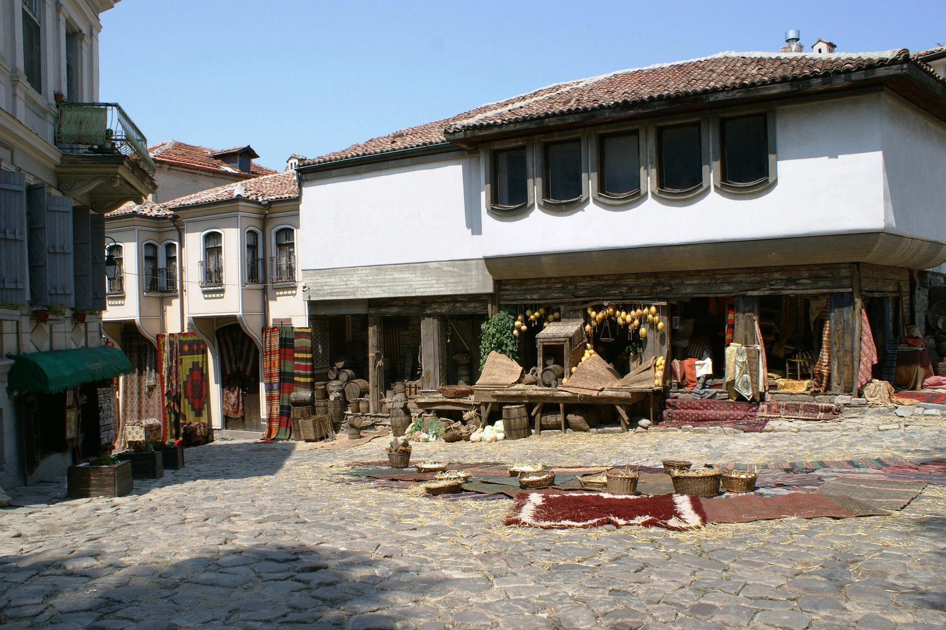 Old Town Plovdiv street scene with Ottoman architecture and traditional market stalls.