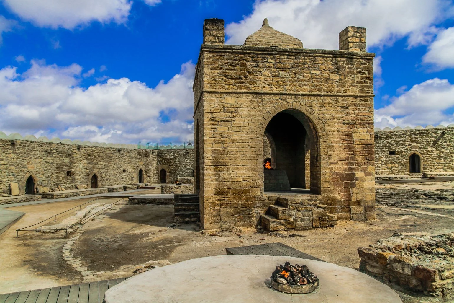 Ancient Ateshgah Fire Temple in Azerbaijan with sacred flame burning inside a stone altar.