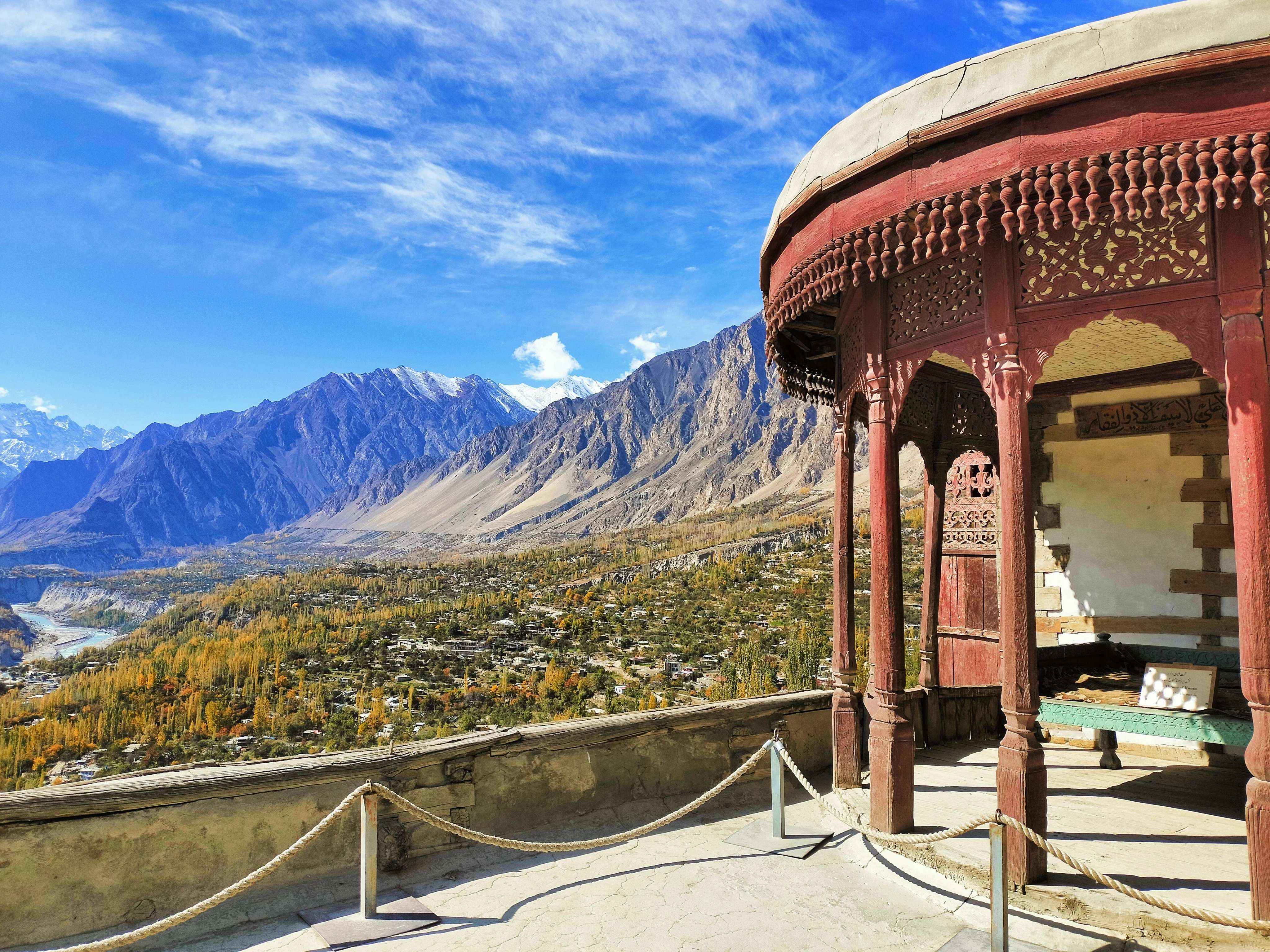 View from Baltit Fort's ornate veranda looking over Hunza Valley's dramatic autumn landscape.
