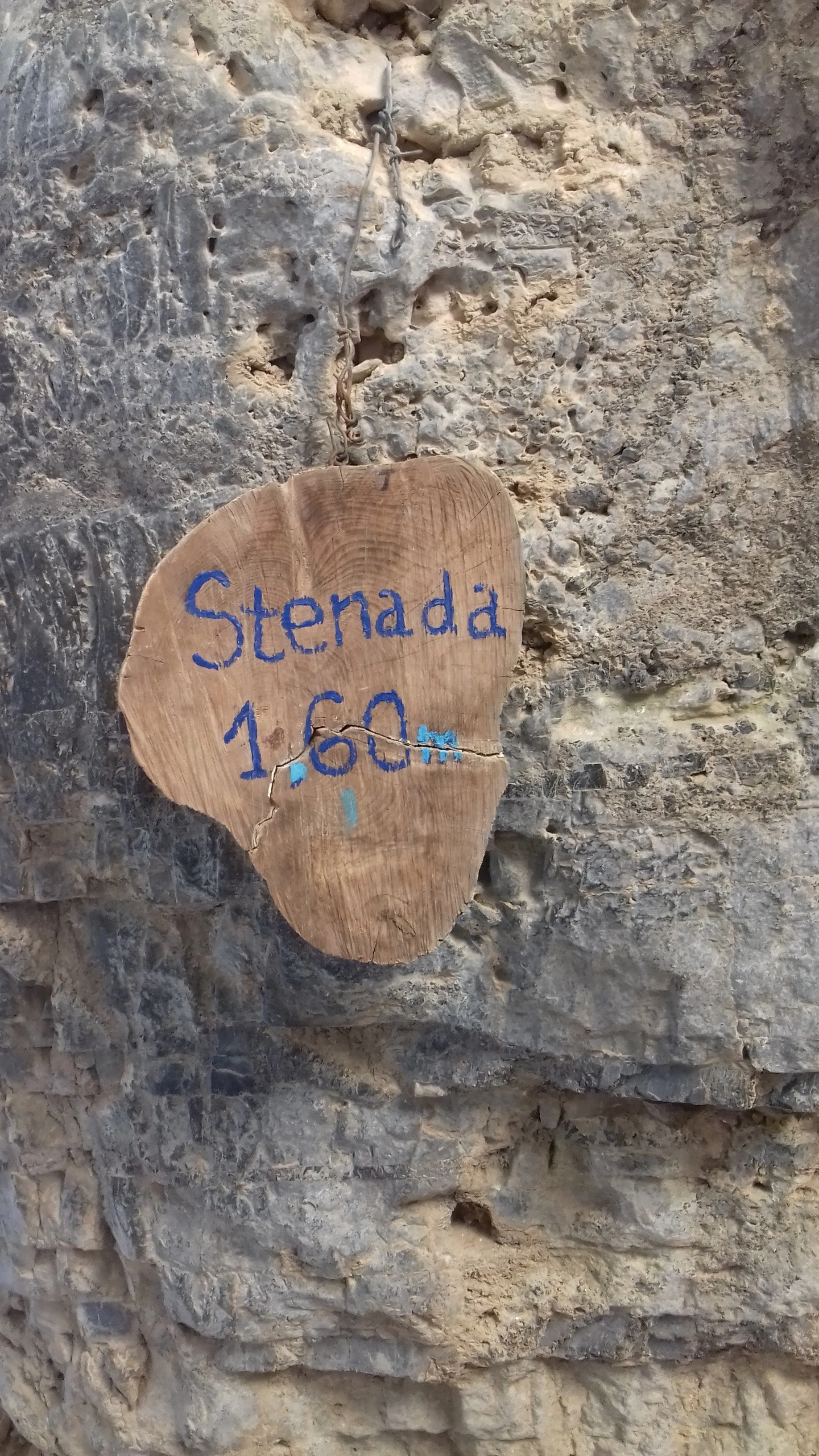 Wooden sign on cliff marks Stenada, the narrowest point in Imbros Gorge at 1.60m wide.
