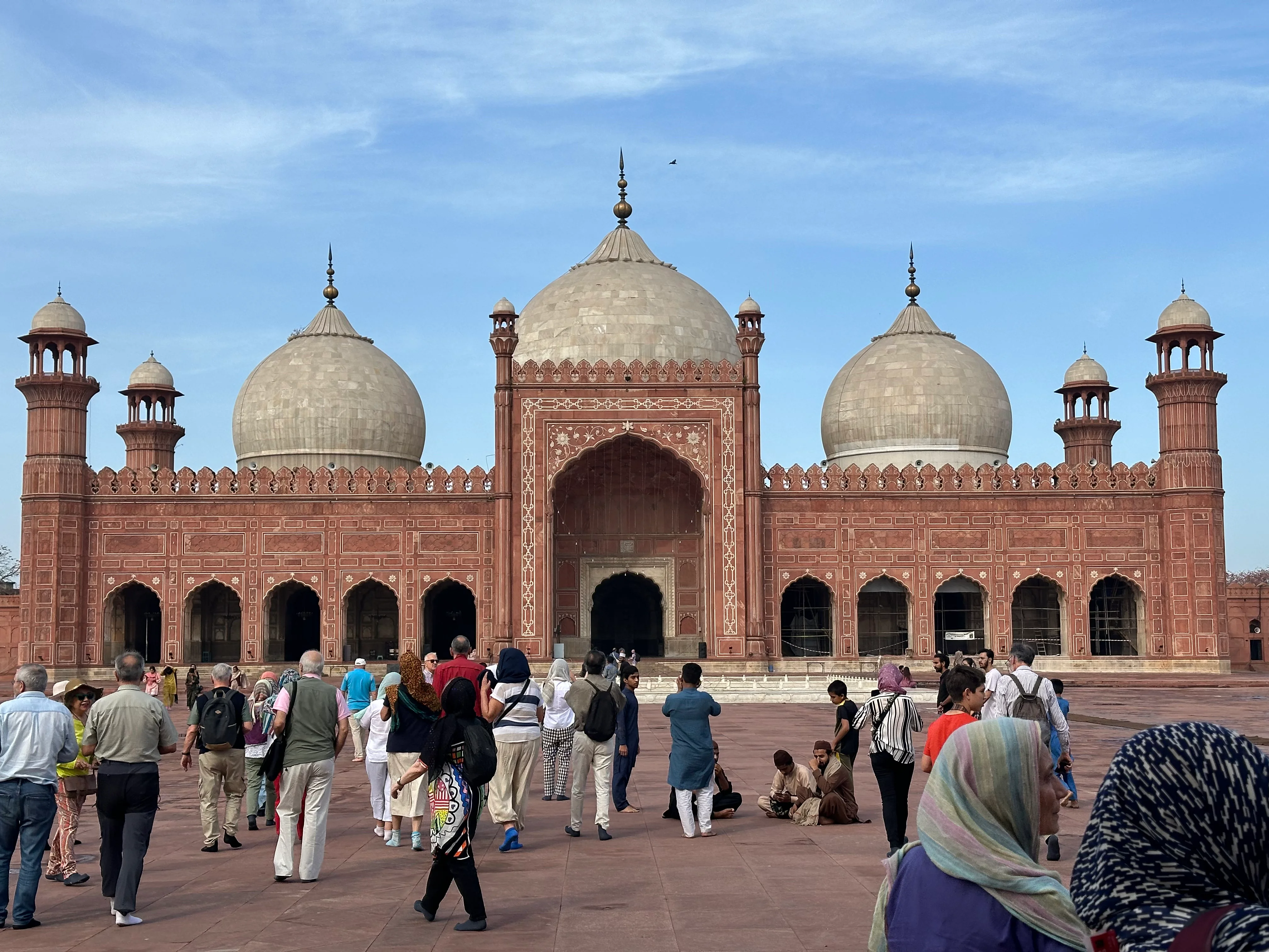 Tourists visiting Badshahi Mosque Lahore, iconic Mughal architecture and grand entrance.