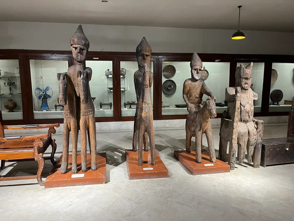Buddhist wooden statues in a museum in Pakistan, traditional heritage art on display.