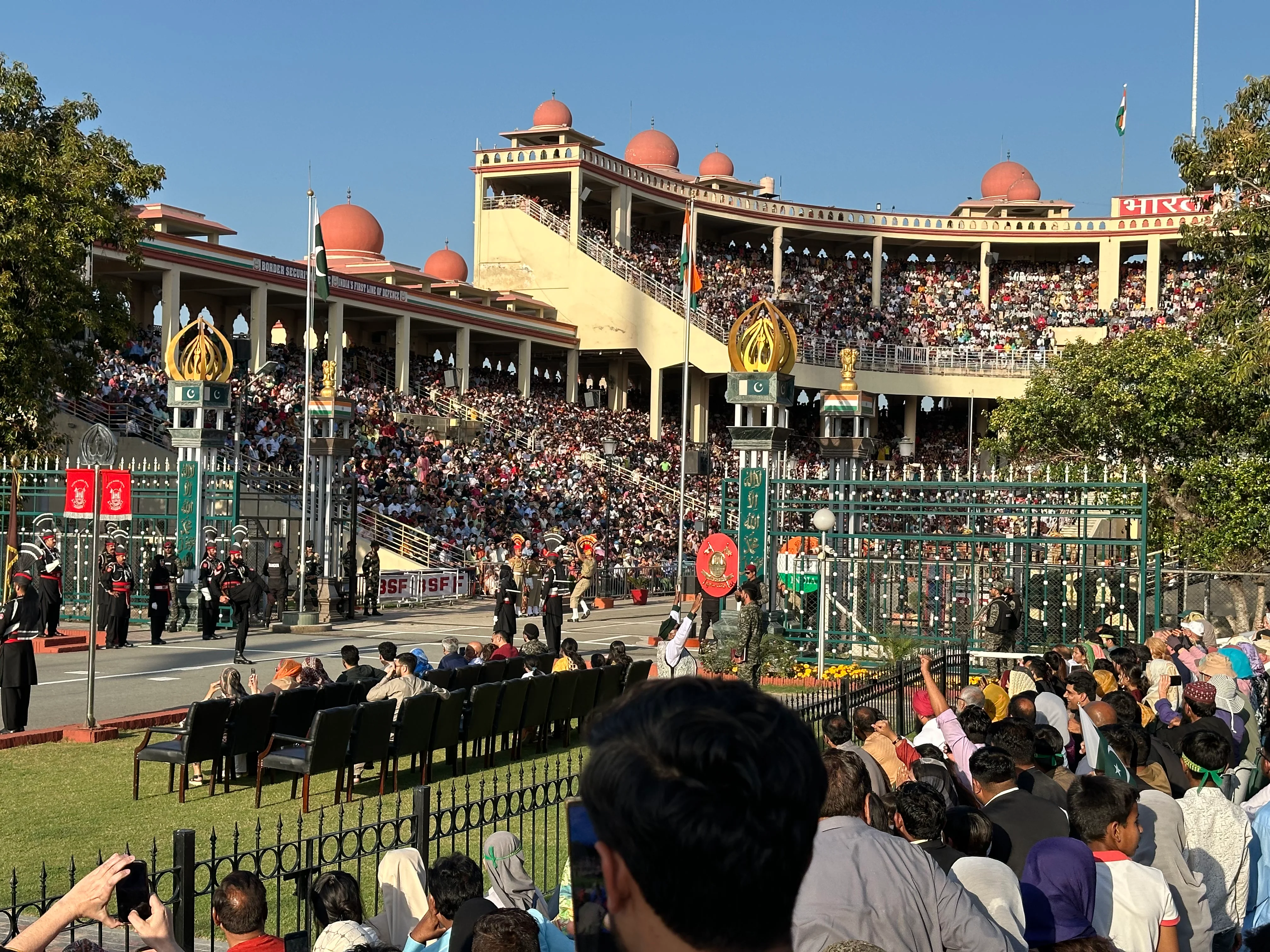 Wagah Border ceremony crowd, Indian and Pakistani soldiers at daily flag lowering.