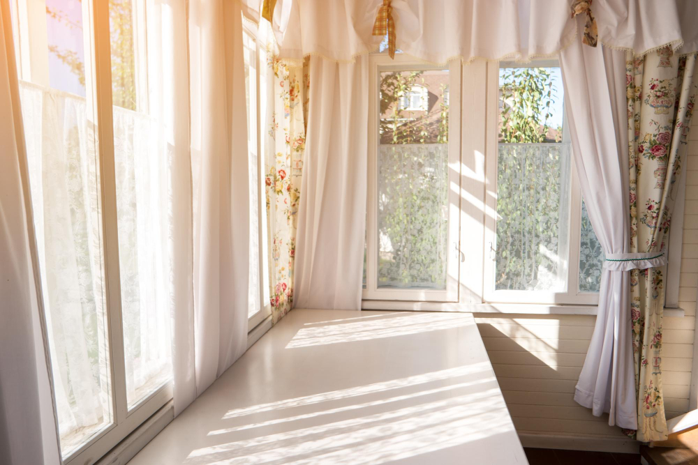 Living room with sunlight streaming through sheer curtains