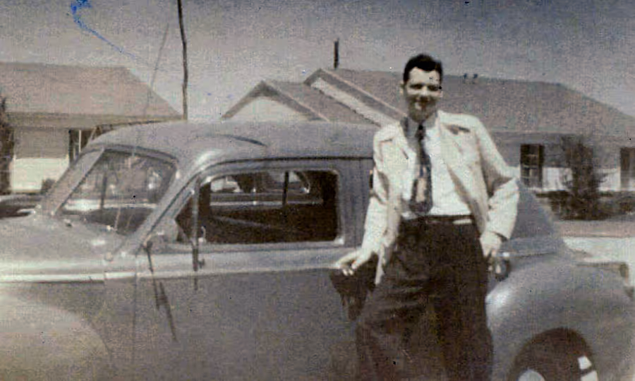 William J. O'Neil in front of his car