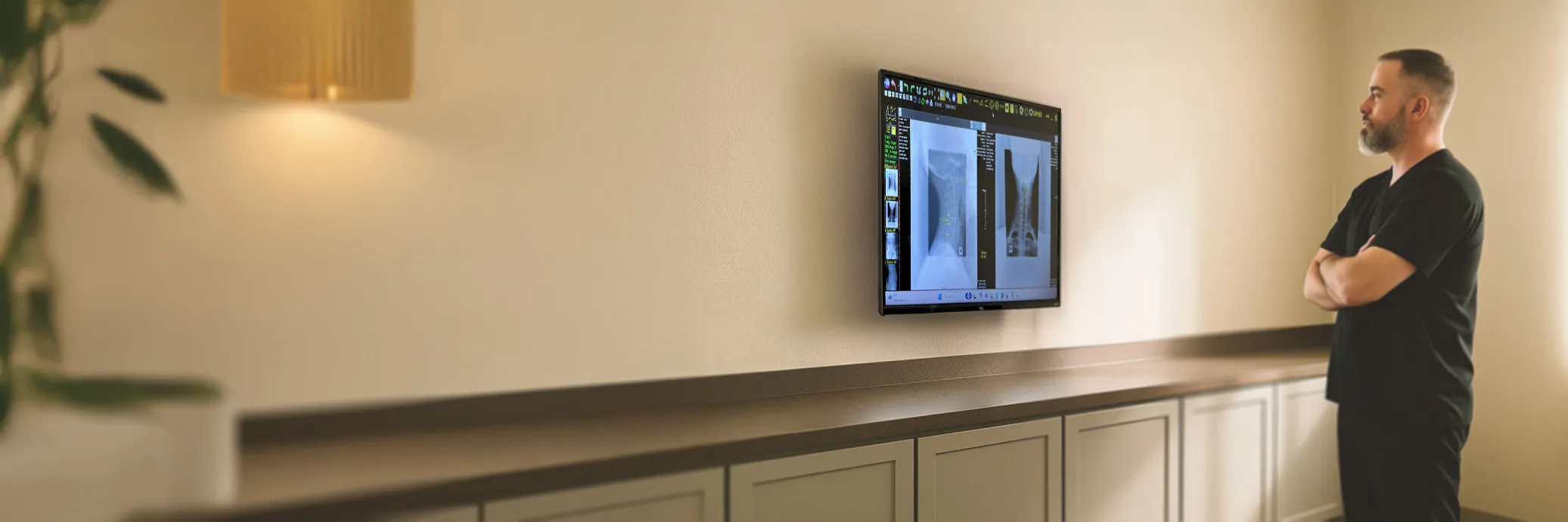 Dr. Brett Payne reviewing cervical X-rays while evaluating possible neck-related hand numbness