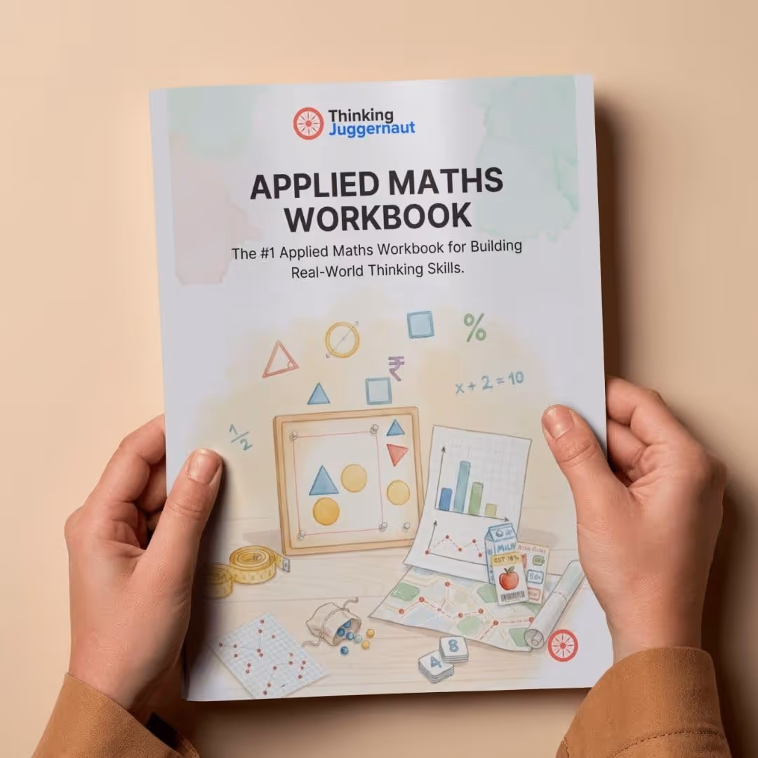 Hands holding an Applied Maths Workbook by Thinking Juggernaut, featuring math symbols, shapes, charts, and a map illustration on the cover.