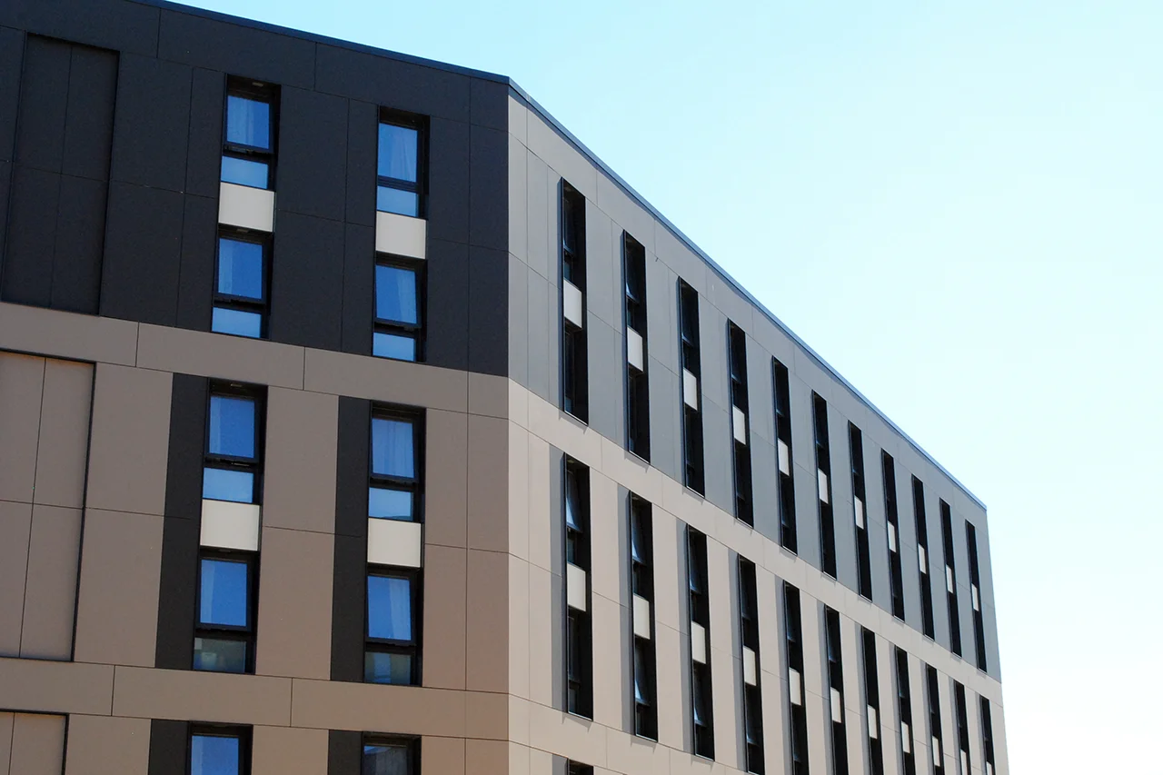 Aldrock contemporary office building with contrasting dark and light composite panel cladding.