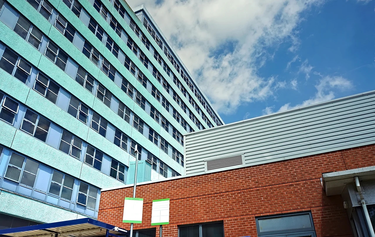 Aldrock high-rise residential tower with distinctive turquoise cladding and ground floor retail units.