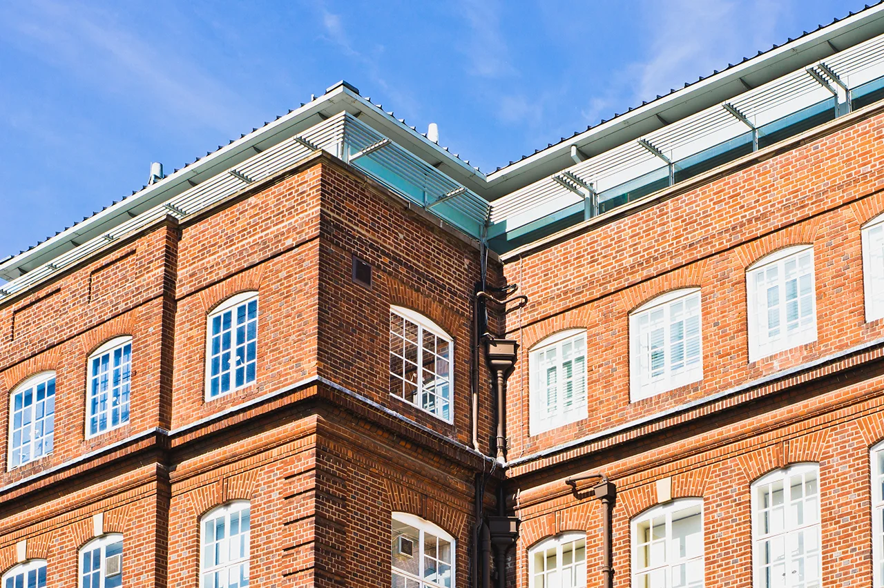 Aldrock heritage building renovation featuring original Victorian brickwork with contemporary glass roof extension.