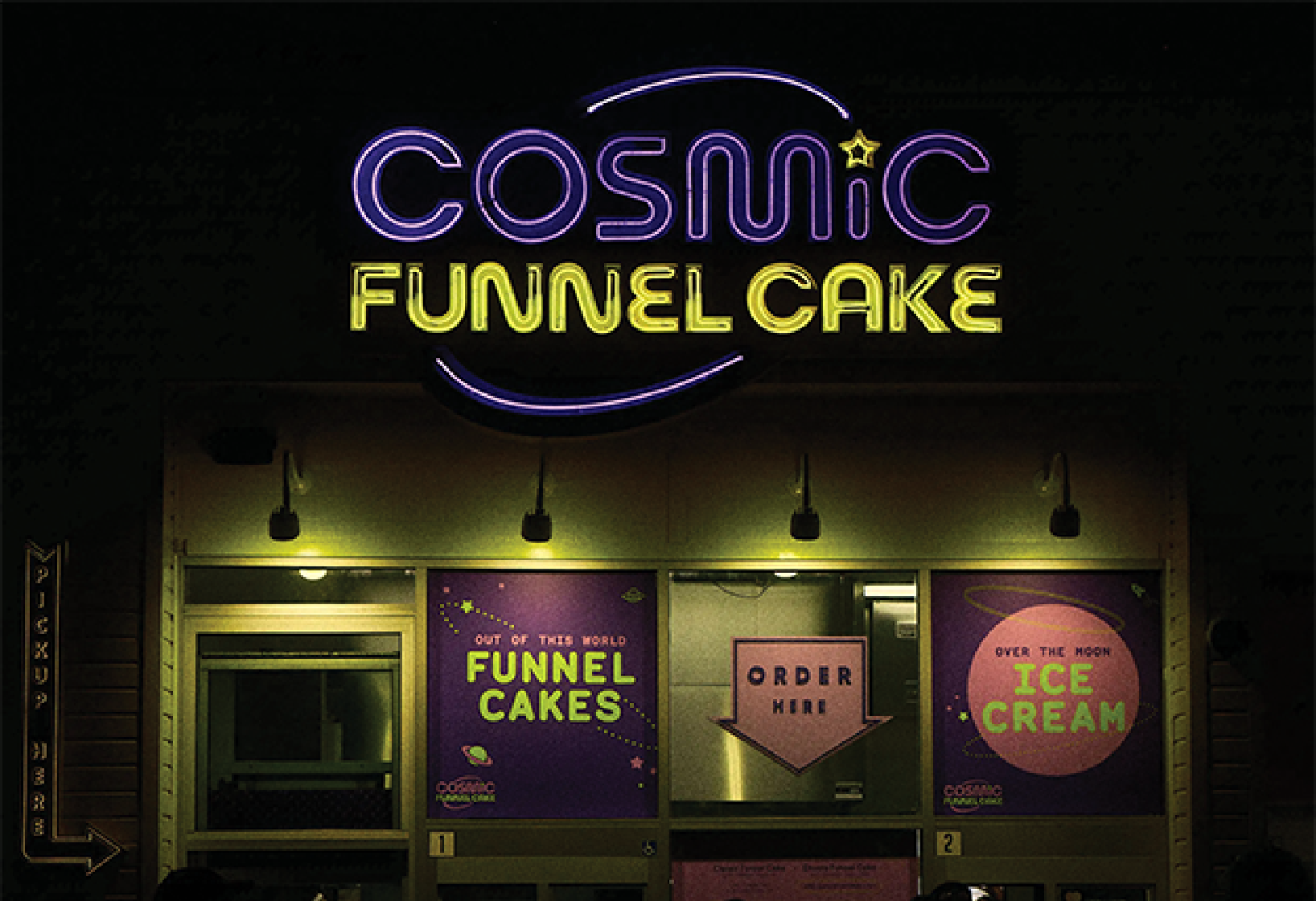 storefront for Cosmic Funnel Cake at night to showcase purple and yellow neon sign