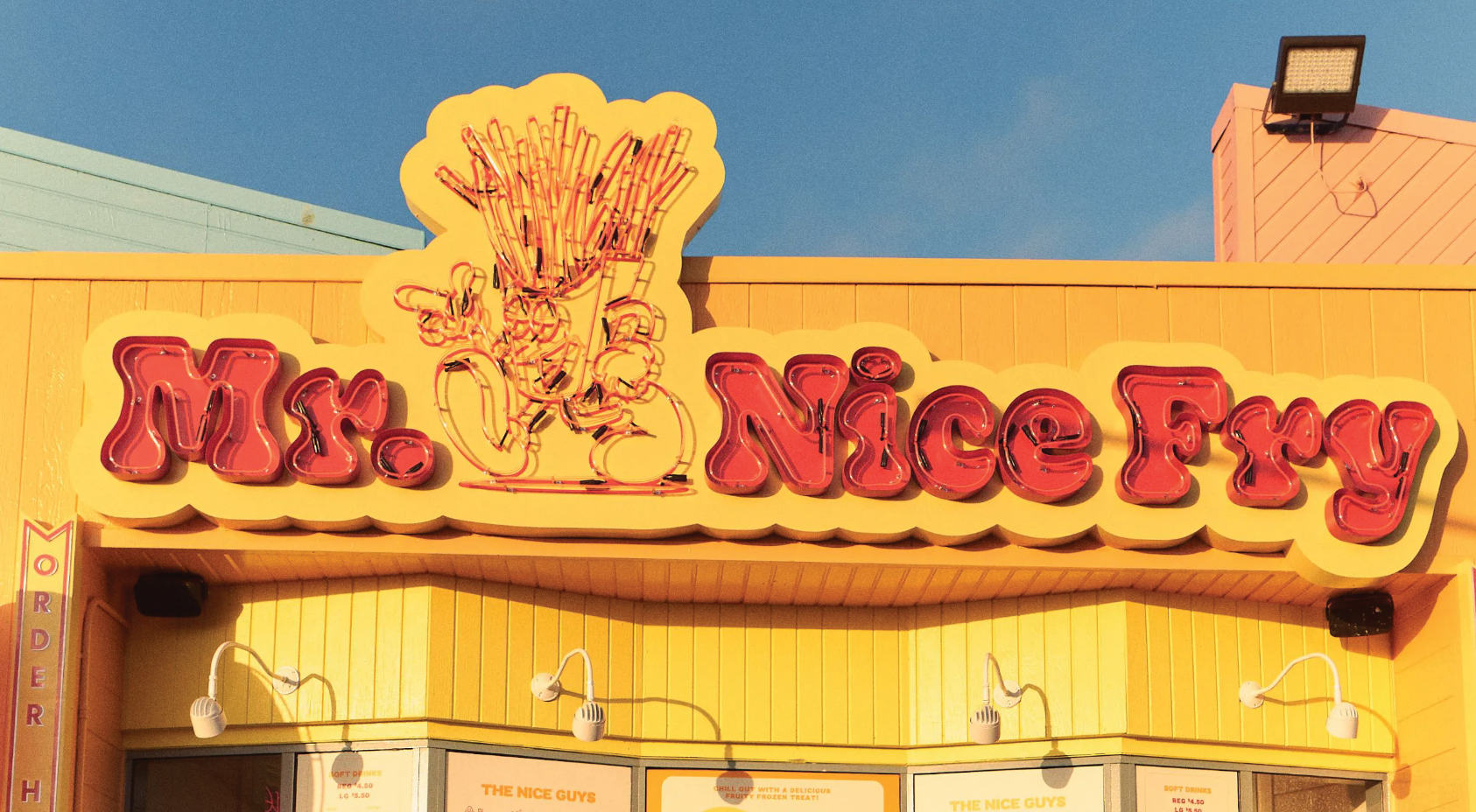 Neon sign for Mr Nice Fry business features typographic text and anthropomorphic french fry character