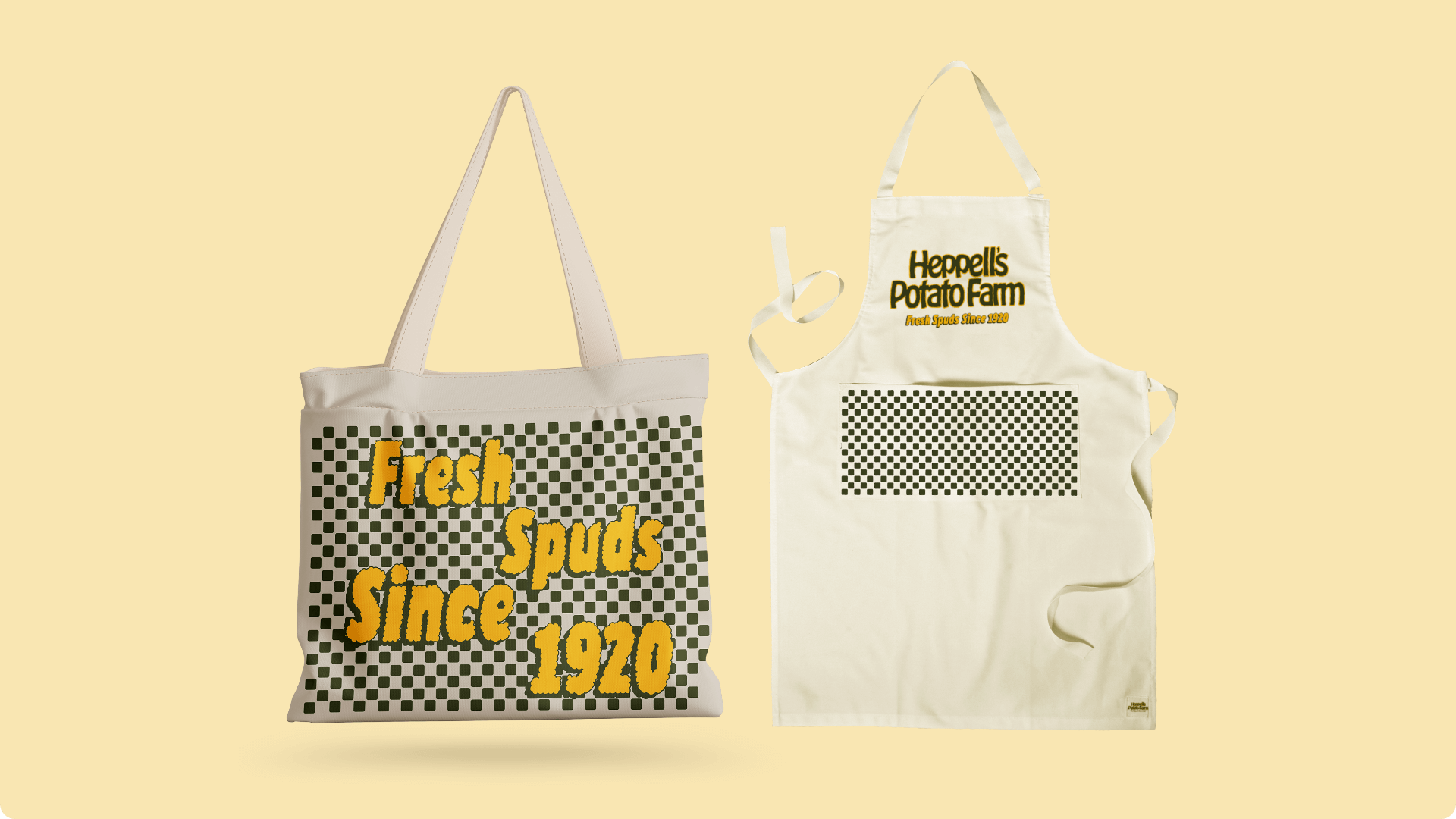 cream tote bag with checkerboard pattern and "fresh spuds since 1920" text and a cream apron with Heppell's Potato Farm text