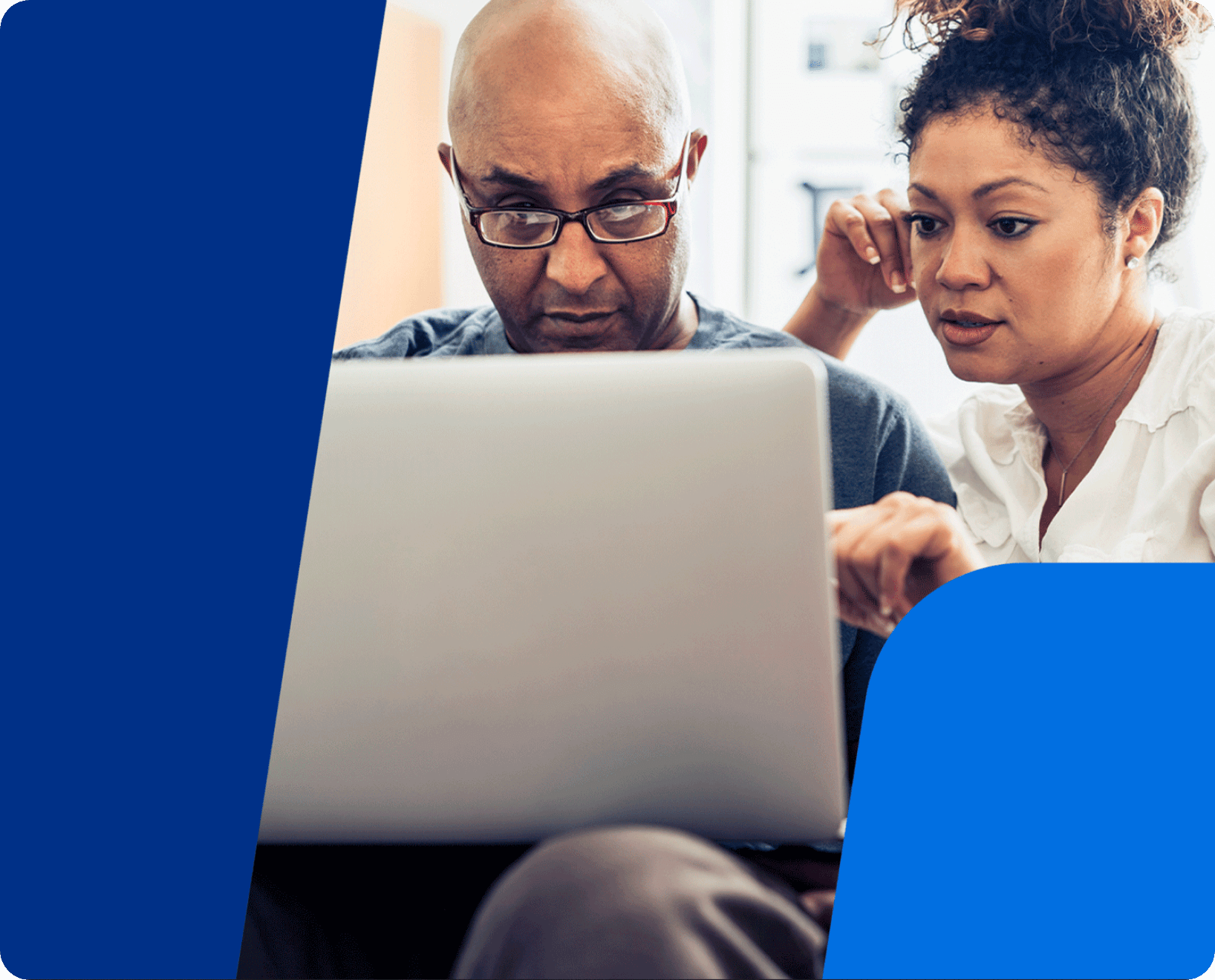 man and woman overlooking laptop