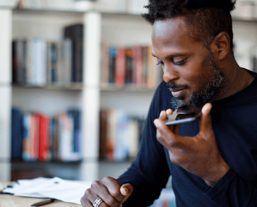 black man talking on phone in library
