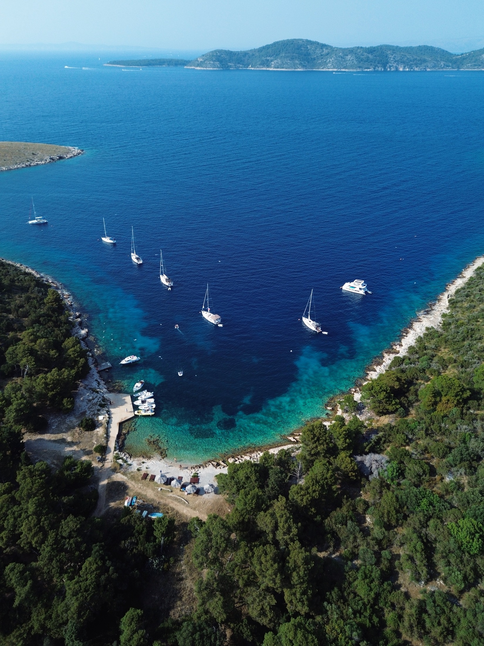 Veleros y catamaranes fondeados en una bahía cerca de Hvar