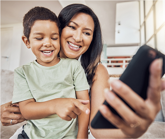 Happy mother and son with a mobile phone