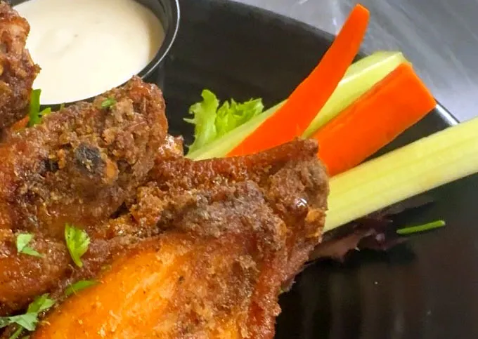 Breaded fish fillets with carrots and celery as a side dish with ranch sauce