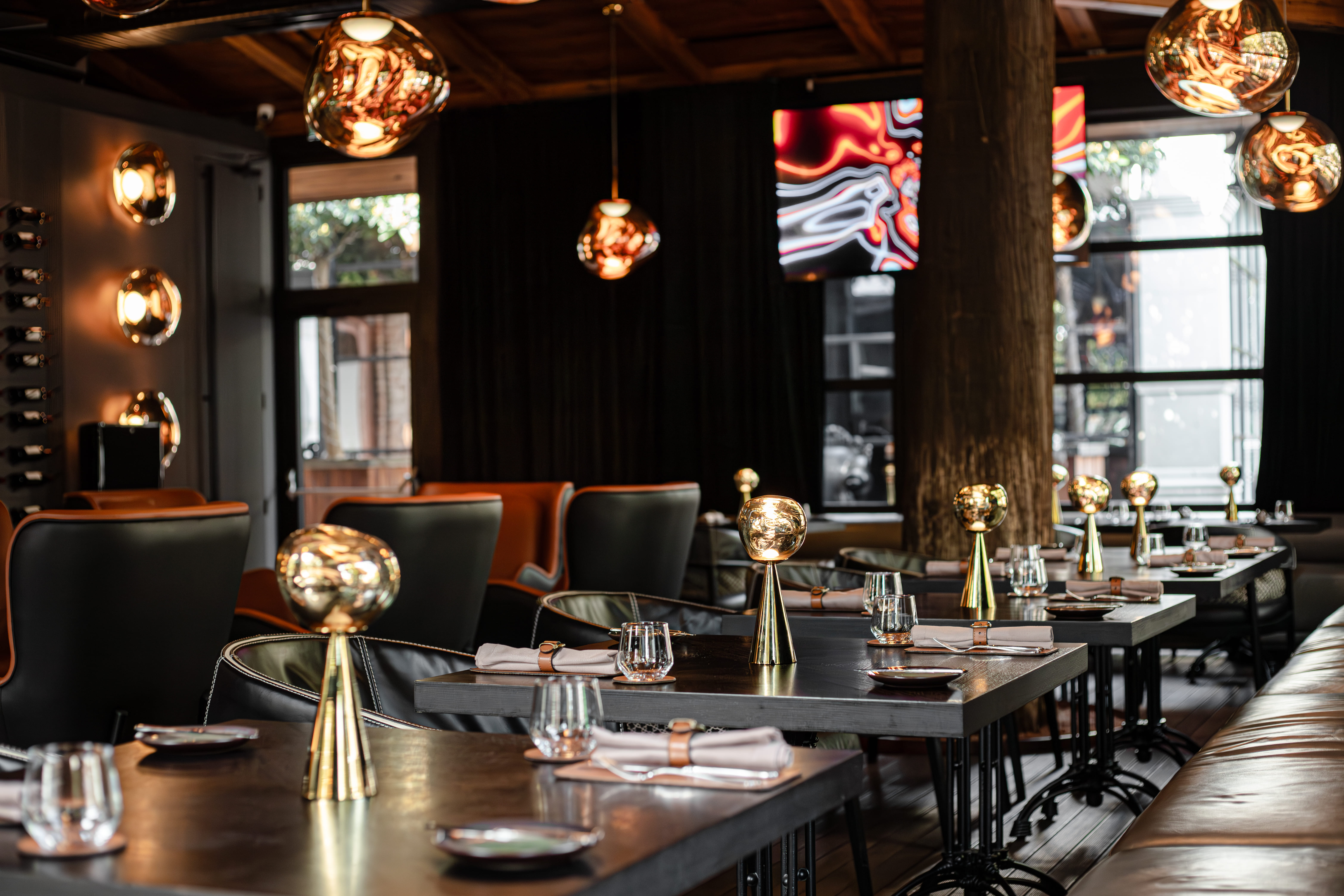 A restaurant located in Batumi, Goegria. Restaurant Secret of Mandarin, in the hotel Mandarin Club House. Dark themed lounge restaurant with Tom Dixon meltin bronze lamps.