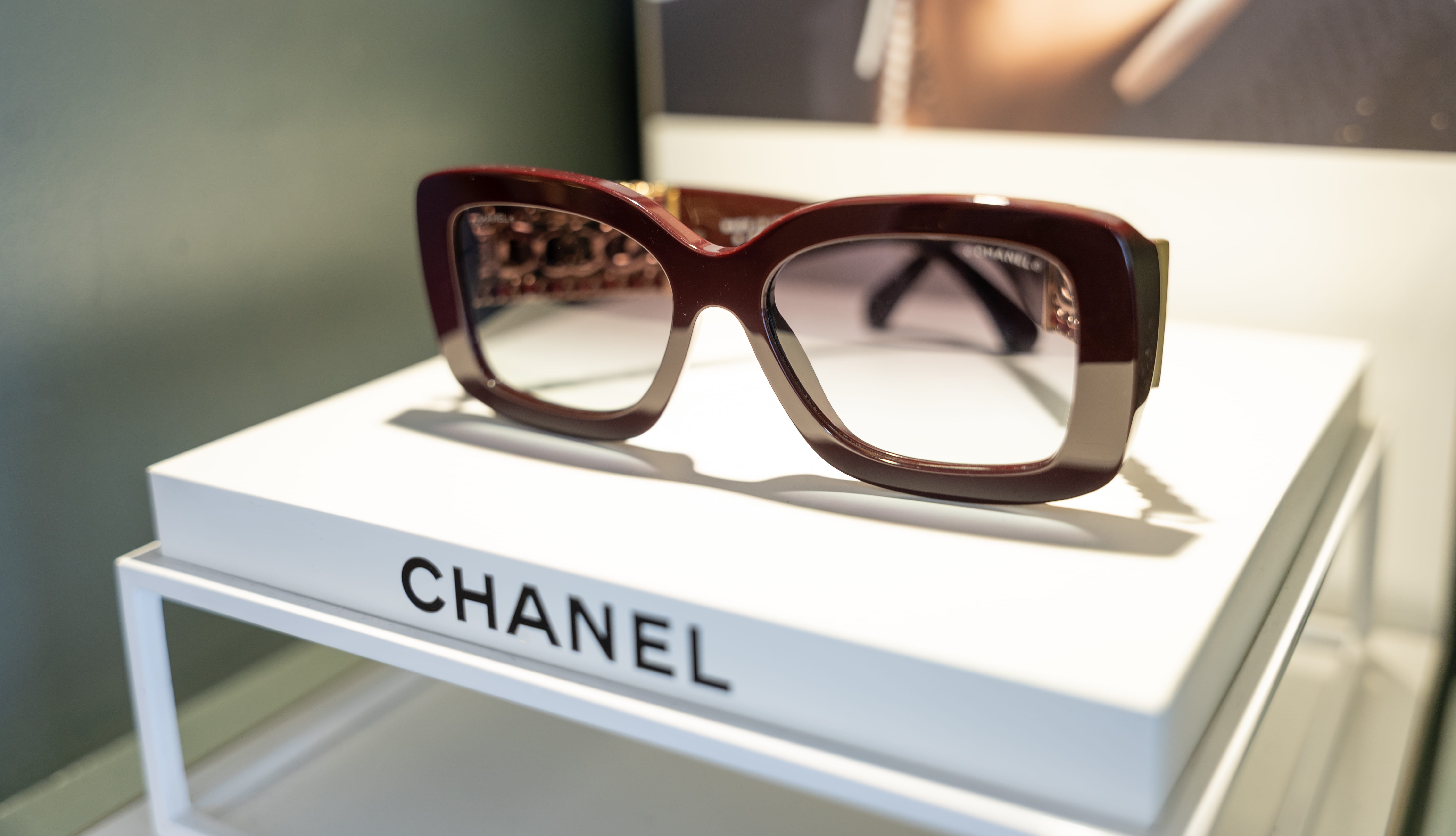 Pair of Chanel sunglasses with brown tortoiseshell frames displayed on white box
