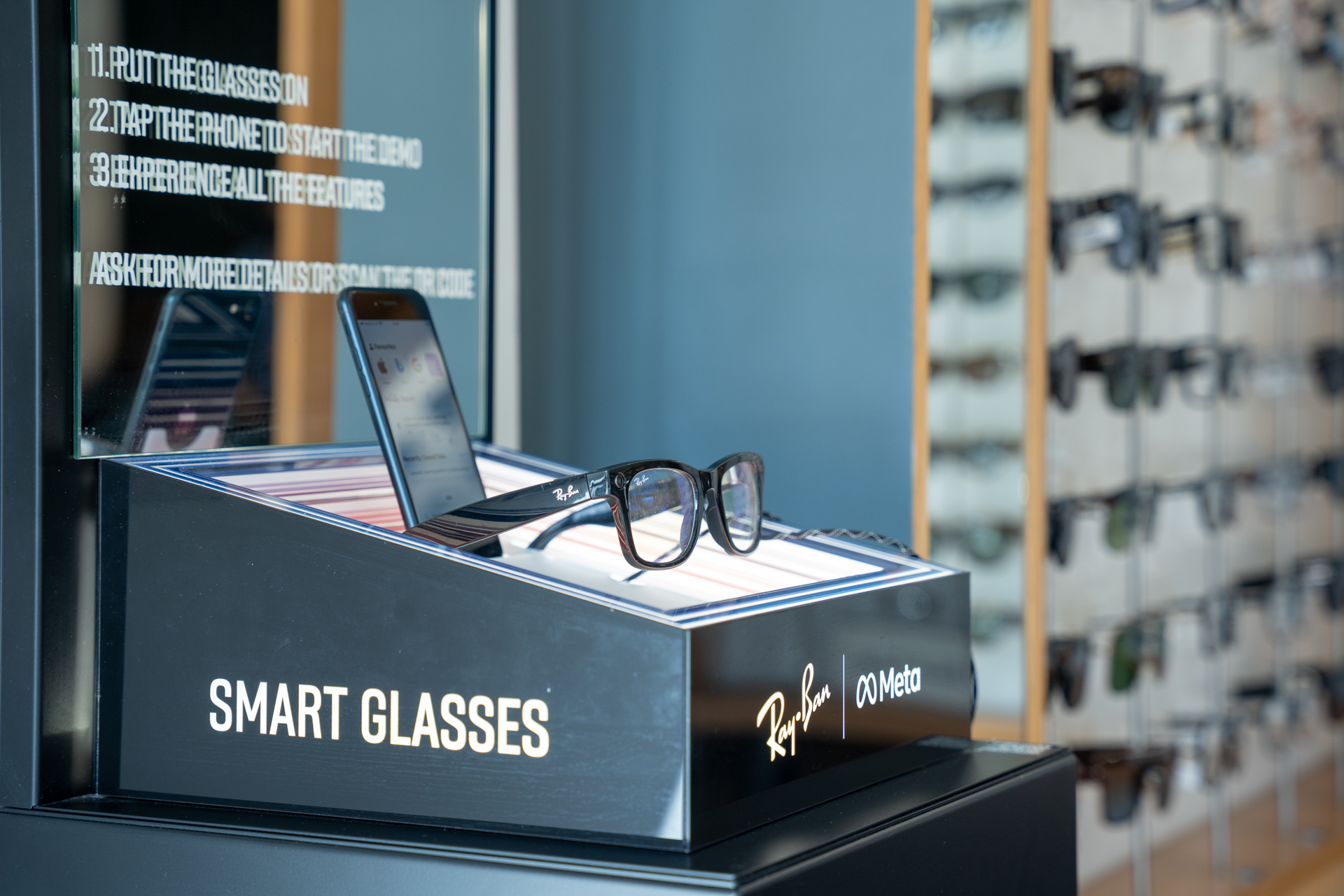 Ray-Ban Meta smart glasses displayed on retail counter with instruction list and smartphone
