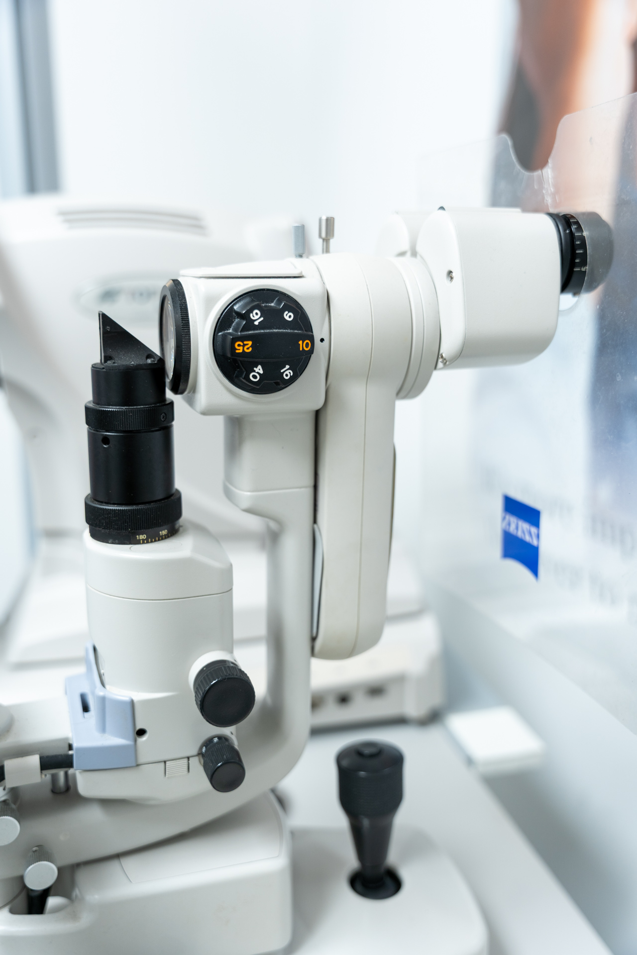 White and black ophthalmic examination equipment with digital display in clinical setting.