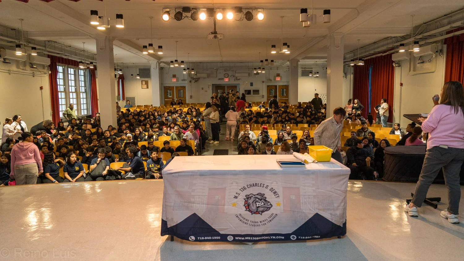 MS 136 students filling auditorium seats during an award ceremony