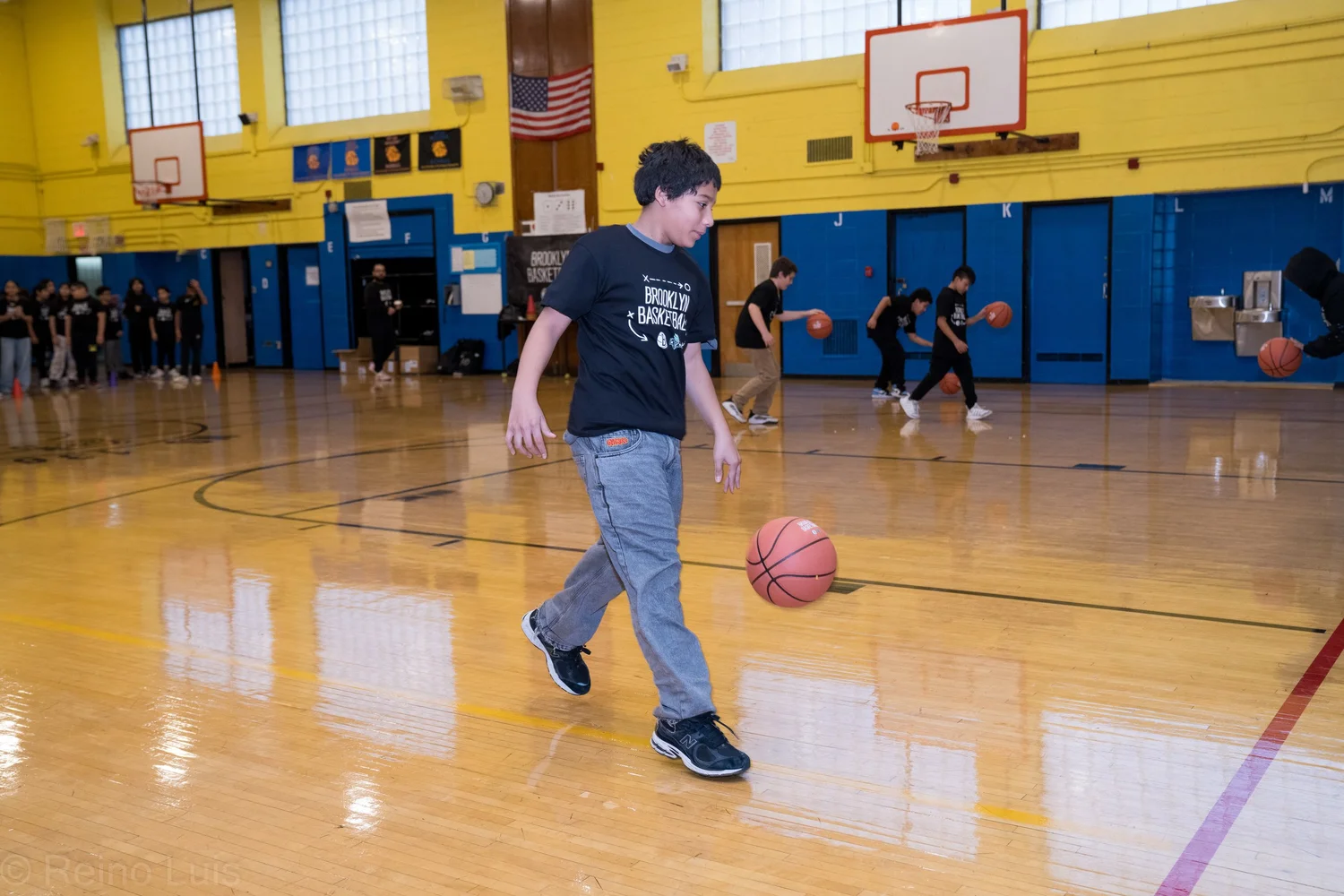 Student dribbling a basketball during Brooklyn Basketball gym program