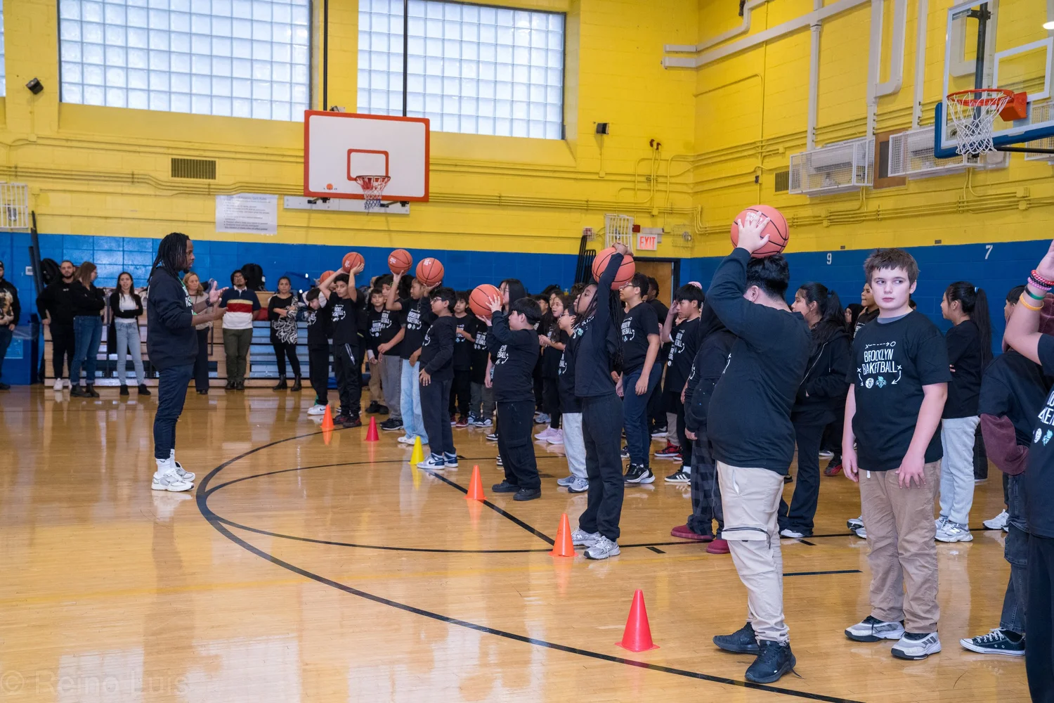 Students practicing basketball drills during Brooklyn Basketball gym visit