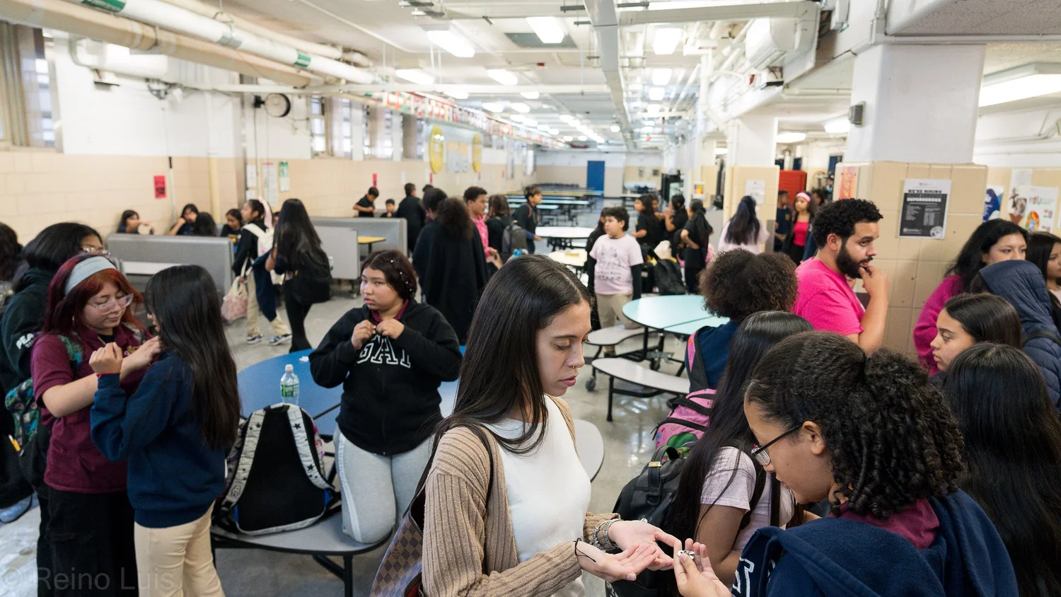 Students socializing in a busy school cafeteria during lunch
