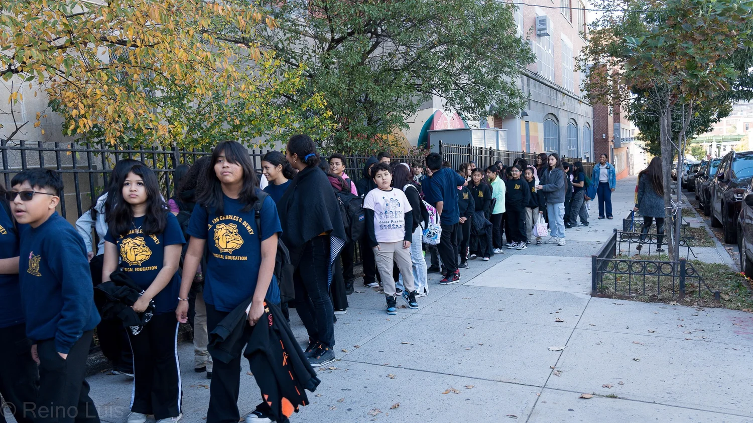 Students in school uniforms lining up outside MS 136 Brooklyn