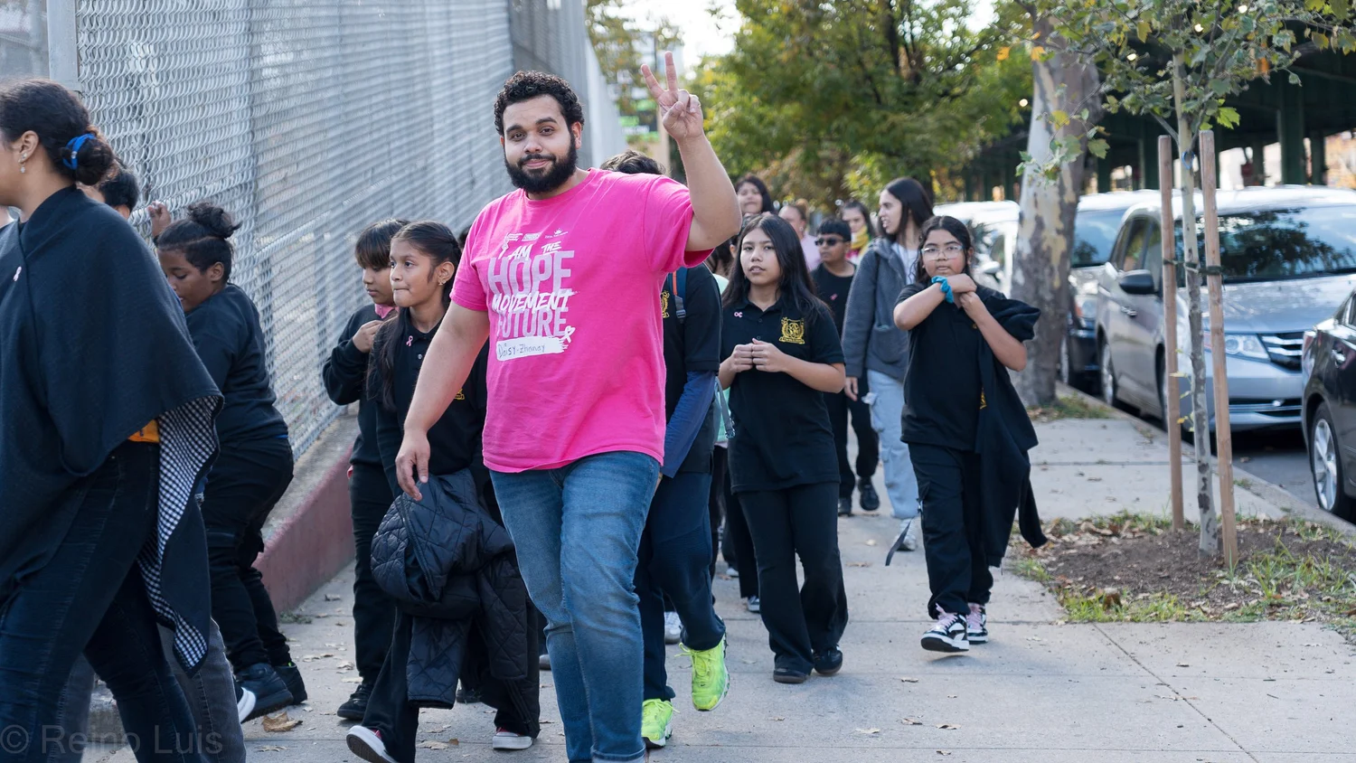 Teacher and students walking together on a sidewalk during school event