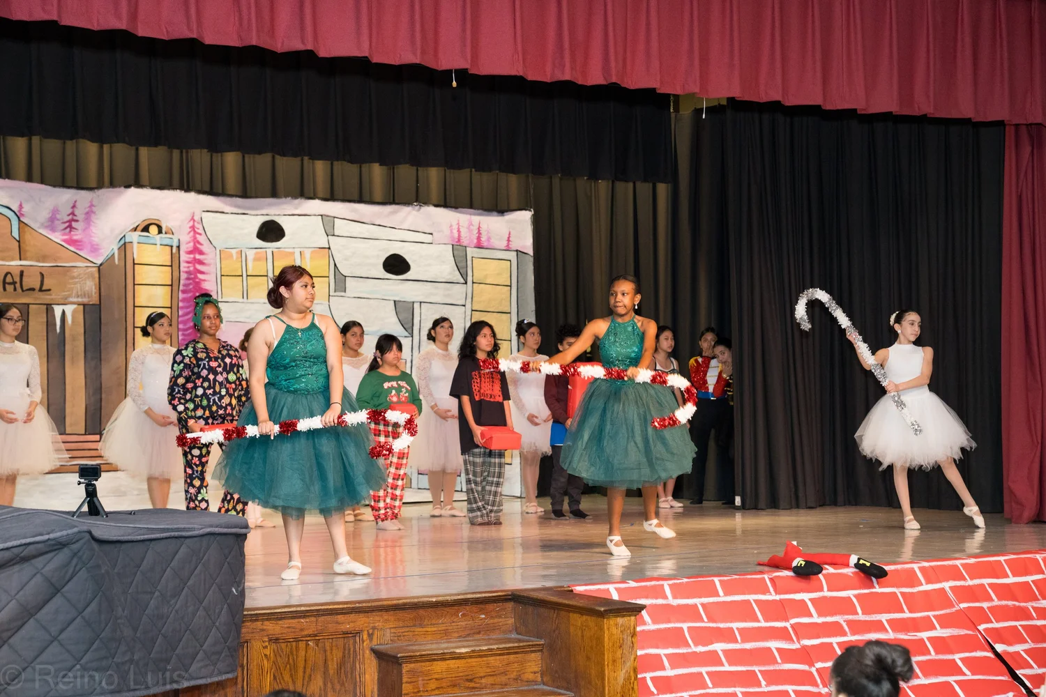 Students performing a holiday dance show on school stage