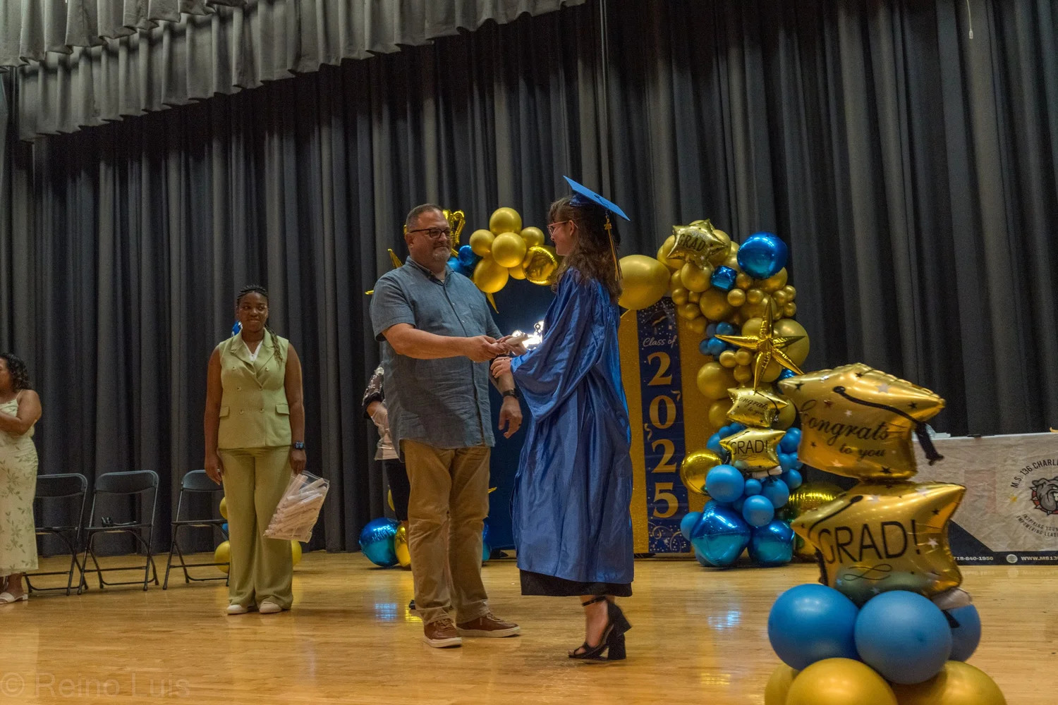 Student receiving diploma on stage at Class of 2025 graduation ceremony