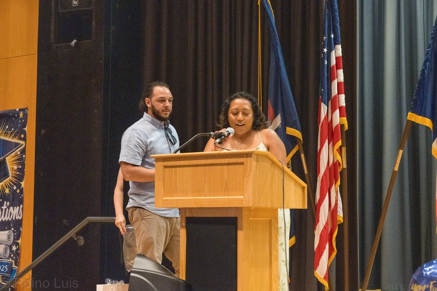 Student speaks at podium during eighth grade graduation ceremony